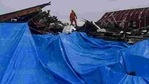 An Indonesian search and rescue personnel inspects a collapsed building following an earthquake in Mamuju, West Sulawesi province, Indonesia on January 16. An Indonesian search and rescue personnel inspects a collapsed building following an earthquake in Mamuju, West Sulawesi province, Indonesia on January 16.