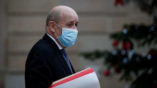 French Foreign Minister Jean Yves Le Drian, wearing a protective face mask, leaves following the weekly cabinet meeting at the Elysee Palace in Paris, France, (Reuters)