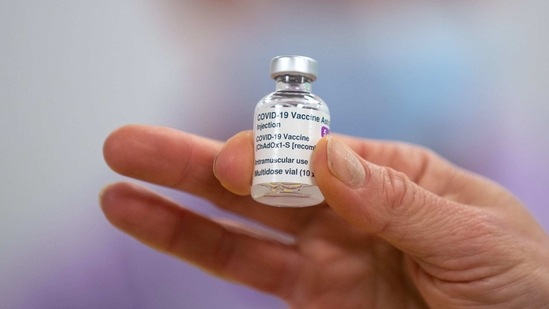 A worker holds a vial of the AstraZeneca Plc and the University of Oxford Covid-19 vaccine.(Bloomberg File Photo )