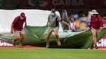 Brisbane: Ground staff bring covers onto the field as the rain stops play on day four of the fourth cricket Test between India and Australia at the Gabba, Brisbane(AP) Brisbane: Ground staff bring covers onto the field as the rain stops play on day four of the fourth cricket Test between India and Australia at the Gabba, Brisbane(AP)
