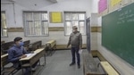 A teacher teaches a lone student in a class after schools in the national capital reopened for classes 10 and 12 on Monday. (PTI) A teacher teaches a lone student in a class after schools in the national capital reopened for classes 10 and 12 on Monday. (PTI)