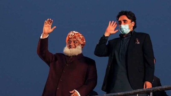 Pakistani politician Maulana Fazlur Rehman and Bilawal Bhutto Zardari, chairman of the Pakistan Peoples Party (PPP), wave to the supporters during an anti-government protest rally organized by the Pakistan Democratic Movement (PDM) in Lahore, Pakistan. (Reuters)