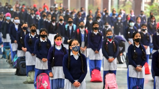 Students attending a Covid-19 safety protocol session at Govt Sarvodaya Girls Senior Secondary School in West Vinod Nagar on January 18. As part of the SOPs issued by the Delhi government last week, schools are to implement staggered timings, have less than 15 students per classroom or laboratory, and ensure “bubbling effect” i.e. students remain in one batch throughout classes, HT reported.(Raj K Raj / HT Photo)