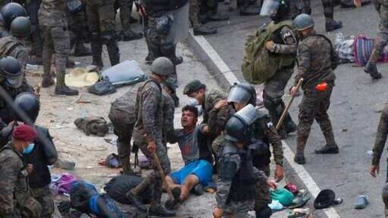 A Honduran migrant is tended to by Guatemalan soldiers after they clashed with them in a bid to reach the US border in Vado Hondo, Guatemala,(AP) A Honduran migrant is tended to by Guatemalan soldiers after they clashed with them in a bid to reach the US border in Vado Hondo, Guatemala,(AP)