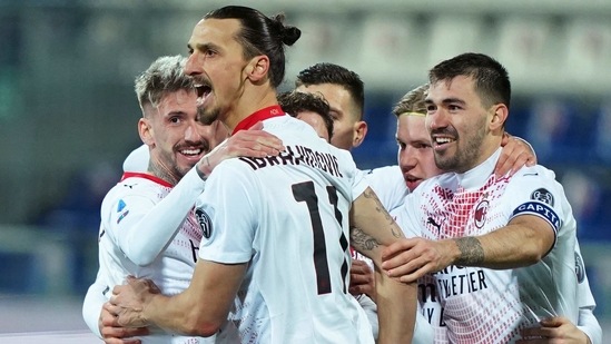 Milan's Zlatan Ibrahimovic, centre, celebrates after scoring the second goal of the game, with Samu Castillejo, left, and Alessio Romagnoli, right, during their Italian Serie A soccer match between Cagliari and Milan at the Sardegna Arena stadium in Cagliari, Italy, Monday, Jan. 18, 2021. (Spada/LaPresse via AP)(AP)