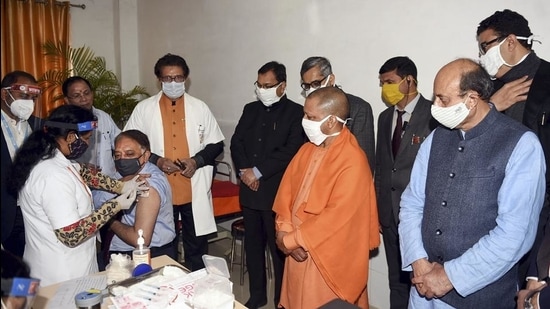 A medic administers the first dose of Covid-19 vaccine to a beneficiary in the presence of Uttar Pradesh chief minister Yogi Adityanath on January 16. (PTI) A medic administers the first dose of Covid-19 vaccine to a beneficiary in the presence of Uttar Pradesh chief minister Yogi Adityanath on January 16. (PTI)