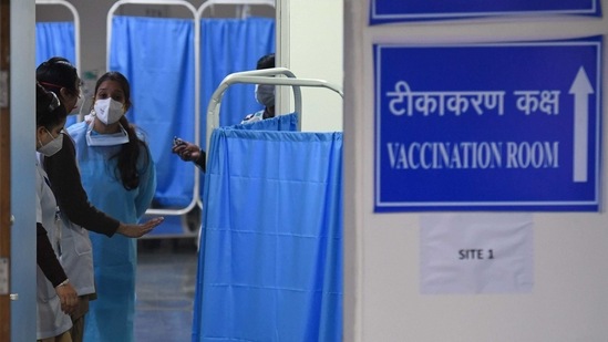 Security and healthcare workers wait for the start of the Covid-19 coronavirus vaccination drive at the RML hospital in New Delhi. (AFP) Security and healthcare workers wait for the start of the Covid-19 coronavirus vaccination drive at the RML hospital in New Delhi. (AFP)