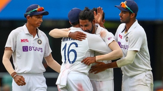 Brisbane : India's Mohammed Siraj, centre, celebrates with teammate Mayank Agarwal, second left, after taking his fifth wicket during play on day four of the fourth cricket test between India and Australia at the Gabba, Brisbane, Australia, Monday, Jan. 18, 2021.AP/PTI(AP01_18_2021_000050A) (AP) Brisbane : India's Mohammed Siraj, centre, celebrates with teammate Mayank Agarwal, second left, after taking his fifth wicket during play on day four of the fourth cricket test between India and Australia at the Gabba, Brisbane, Australia, Monday, Jan. 18, 2021.AP/PTI(AP01_18_2021_000050A) (AP)