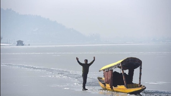 A boatman stands on a frozen Dal lake in Srinagar. (HT file) A boatman stands on a frozen Dal lake in Srinagar. (HT file)