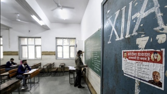 A teacher takes a class in a Delhi school. Schools in the national capital reopened for students of classes 10 and 12 on Monday. (PTI)