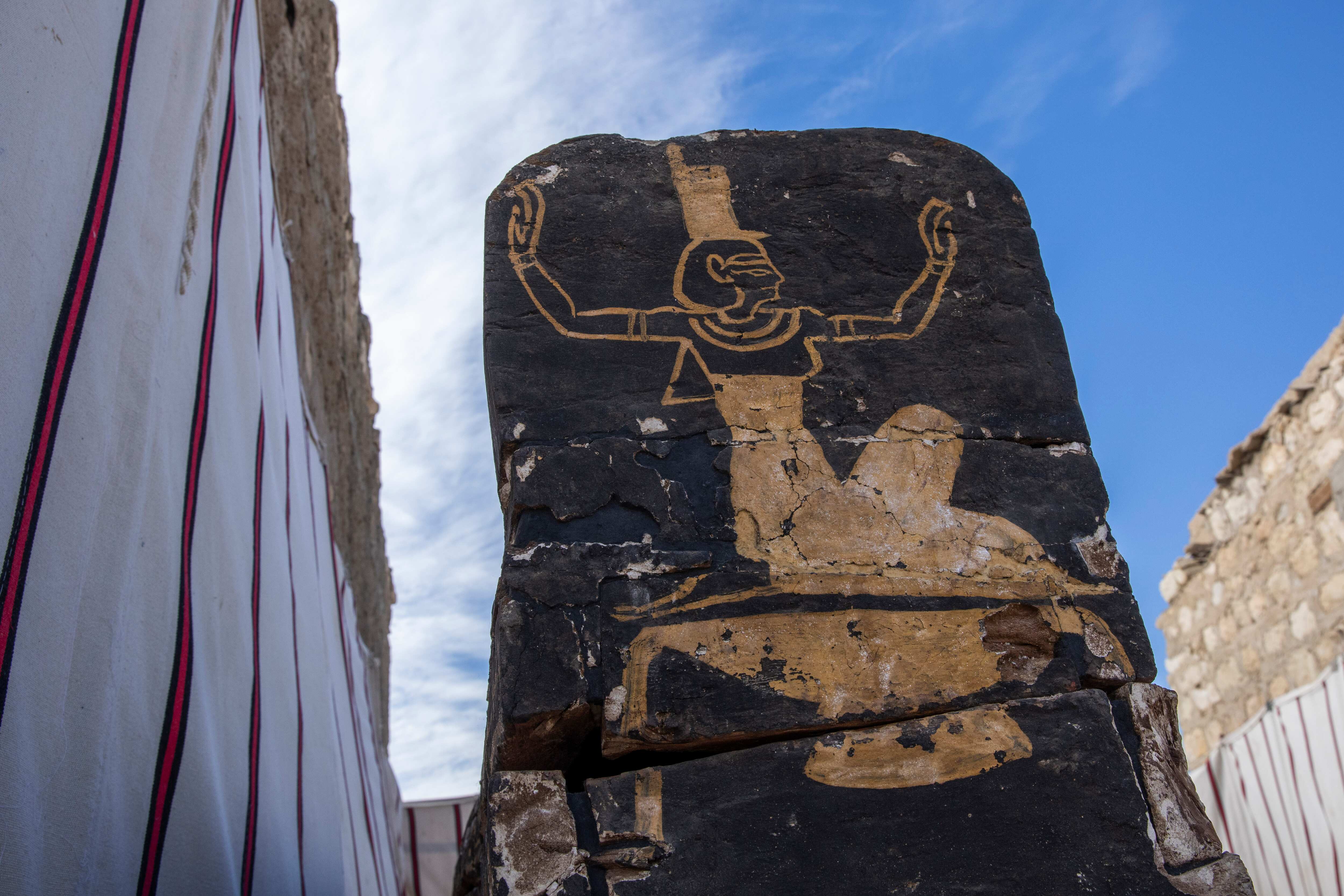 An ancient coffin is on display that Egyptian archaeologist Zahi Hawass and his team unearthed in a vast necropolis filled with burial shafts, coffins and mummies dating back to the New Kingdom 3000 BC, Sunday, Jan. 17, 2021, in Saqqara, south of Cairo, Egypt. (AP)
