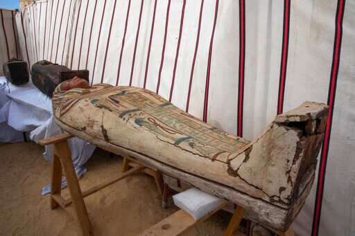 An ancient coffins is on display that Egyptian archaeologist Zahi Hawass and his team unearthed in a vast necropolis filled with burial shafts, coffins and mummies dating back to the New Kingdom 3000 BC, Sunday, Jan. 17, 2021, in Saqqara, south of Cairo, Egypt. (AP)