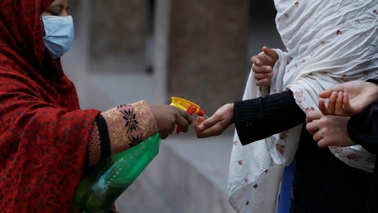 Students get sanitised before entering classrooms as secondary schools reopen amid the second wave of the coronavirus disease outbreak, in Peshawar, Pakistan. (Reuters)