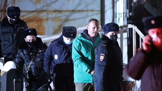 Russian opposition leader Alexei Navalny is escorted by police officers after a court hearing, in Khimki outside Moscow, Russia. (via REUTERS)