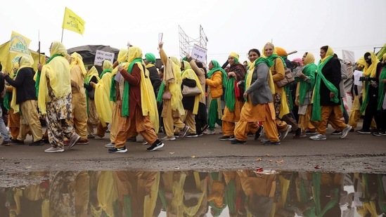 Women farmers carry placards and flags during a protest against the new farm laws on the Women Farmer Day at Singhu Border, in New Delhi.(ANI) Women farmers carry placards and flags during a protest against the new farm laws on the Women Farmer Day at Singhu Border, in New Delhi.(ANI)
