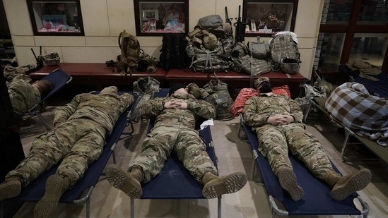 National Guard troops sleeping inside the Capitol Visitor's Center at the US Capitol in Washington, on January 18. BIden's inauguration comes just two weeks after the outgoing president’s loyalists waged a deadly riot to block the change of power.(J. Scott Applewhite / AP Photo)