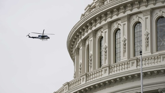 A police helicopter makes a survey of the Capitol after an announcement of security problems during a rehearsal for the Presidential Inauguration at the US Capitol in Washington on January 18.(J. Scott Applewhite / AP)