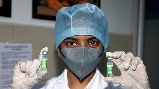 A medic worker shows Covishield vials during Covid-19 vaccination programme, at BAPS Hospital in Surat, Gujarat. (File photo)