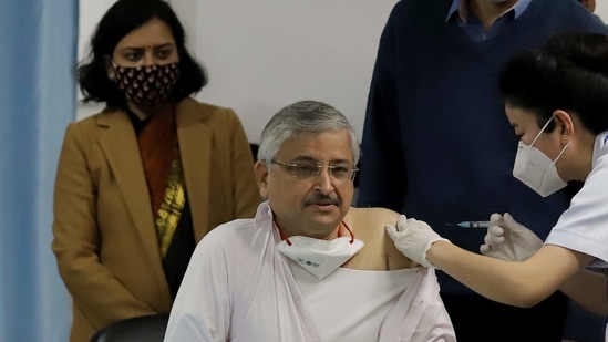 AIIMS director Randeep Guleria receives a dose of the Bharat Biotech's Covaxin on Saturday.(Bloomberg)