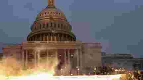 An explosion caused by a police munition is seen while supporters of US President Donald Trump gather in front of the US Capitol Building in Washington, January 6, 2021. (REUTERS) An explosion caused by a police munition is seen while supporters of US President Donald Trump gather in front of the US Capitol Building in Washington, January 6, 2021. (REUTERS)