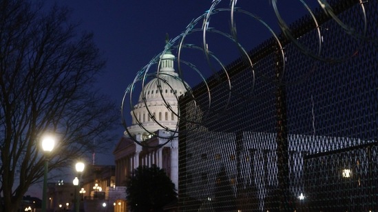 Riot fencing and razor wire reinforce the security zone on Capitol Hill in Washington before President-elect Joe Biden is sworn in as the 46th president on Wednesday. (AP) Riot fencing and razor wire reinforce the security zone on Capitol Hill in Washington before President-elect Joe Biden is sworn in as the 46th president on Wednesday. (AP)