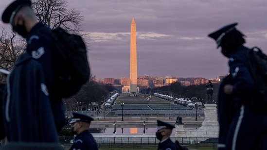 The Washington Monument and the National Mall are visible as members of the US Air Force Honor Guard walk along the West Front of the US Capitol at the site of the 59th Presidential Inauguration, on January 18. In the Capitol Hill area, streets that are usually busy and traffic-clogged have been largely empty. Residents have been warned that cars within the exclusion zone would have to stay there until after the inauguration.(Andrew Harnik / REUTERS)