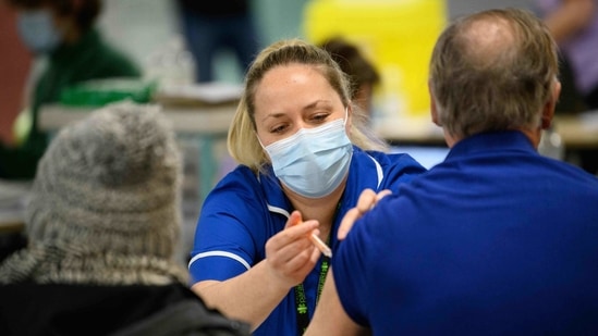 A member of the medical team administers a coronavirus Covid-19 vaccine shot at the NHS vaccination centre in Robertson House in Stevenage, north of London on January 14, 2021 (Photo by Leon Neal / POOL / AFP)(AFP) A member of the medical team administers a coronavirus Covid-19 vaccine shot at the NHS vaccination centre in Robertson House in Stevenage, north of London on January 14, 2021 (Photo by Leon Neal / POOL / AFP)(AFP)
