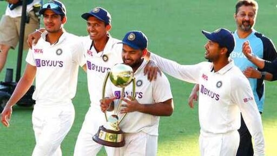 India's Rishabh Pant carries the trophy as he celebrates with his teammates after defeating Australia by three wickets on the final day of the fourth cricket Test at the Gabba, Brisbane, Australia(AP)