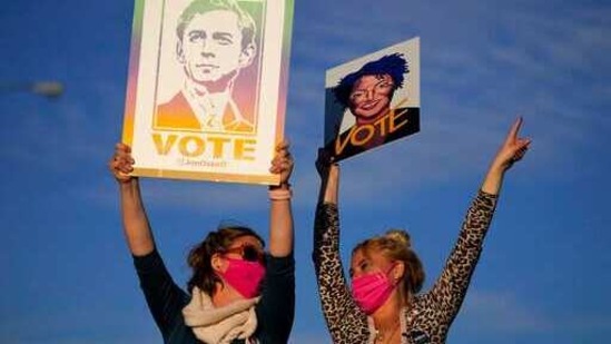 Supporters cheer as President-elect Joe Biden campaigns for Senate candidates Raphael Warnock and Jon Ossoff.(AP) Supporters cheer as President-elect Joe Biden campaigns for Senate candidates Raphael Warnock and Jon Ossoff.(AP)