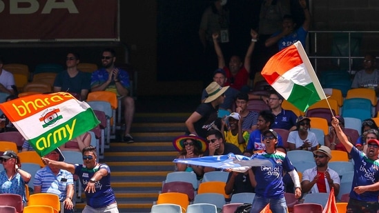 Indian supporters wave flags as they cheer their team during play on the final day of the fourth cricket test between India and Australia at the Gabba, Brisbane, Australia, Tuesday, Jan. 19, 2021. (AP Photo/Tertius Pickard)(AP)