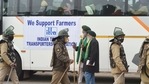 Police personnel walk past a bus with farmer leaders before it leaves for Vigyan Bhawan to attend a meeting with the central government over the new farm laws, at Singhu border near Delhi on Wednesday.(PTI Photo) Police personnel walk past a bus with farmer leaders before it leaves for Vigyan Bhawan to attend a meeting with the central government over the new farm laws, at Singhu border near Delhi on Wednesday.(PTI Photo)