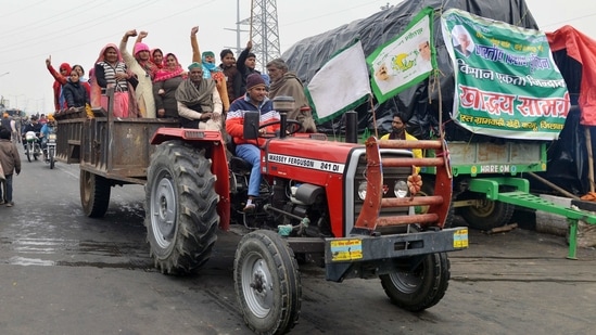 Farmers raise slogans as they ride tractor during an ongoing protest against the new farm laws, at the Delhi-Ghazipur border on Monday.(ANI Photo) Farmers raise slogans as they ride tractor during an ongoing protest against the new farm laws, at the Delhi-Ghazipur border on Monday.(ANI Photo)