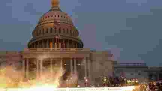 An explosion caused by a police munition is seen while supporters of US President Donald Trump gather in front of the US Capitol Building in Washington, January 6, 2021. (REUTERS) An explosion caused by a police munition is seen while supporters of US President Donald Trump gather in front of the US Capitol Building in Washington, January 6, 2021. (REUTERS)