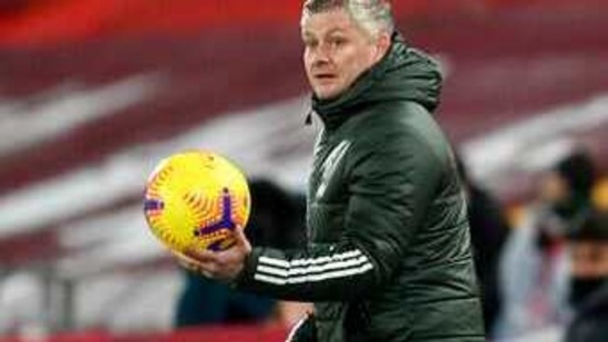 Manchester United's manager Ole Gunnar Solskjaer holds the ball during the English Premier League soccer match between Liverpool and Manchester United at Anfield Stadium, Liverpool, England, Sunday, Jan. 17, 2021. (Michael Regan/Pool via AP)(AP)