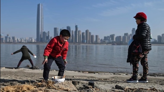 A child plays on the banks of the Yangtze river in Wuhan, China, on January 19, 2021. (AFP) A child plays on the banks of the Yangtze river in Wuhan, China, on January 19, 2021. (AFP)