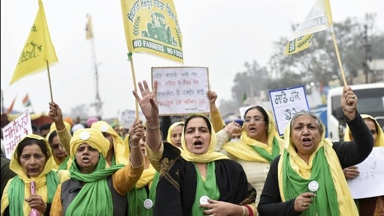 Women raise slogans during the farmers' protest against new farm laws, at Singhu border in New Delhi, Monday. (PTI)