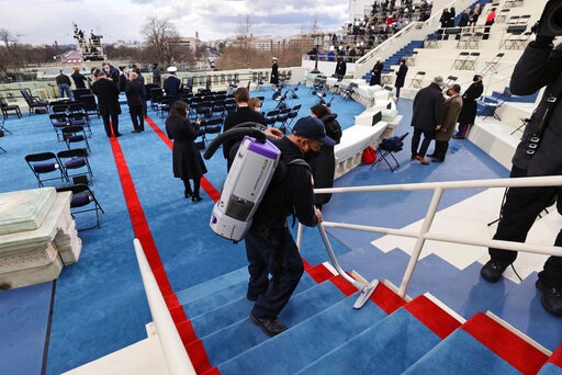A worker vacuums stairs as preparations are made ahead of President-elect Joe Biden's inauguration ceremony in Washington. (AP)