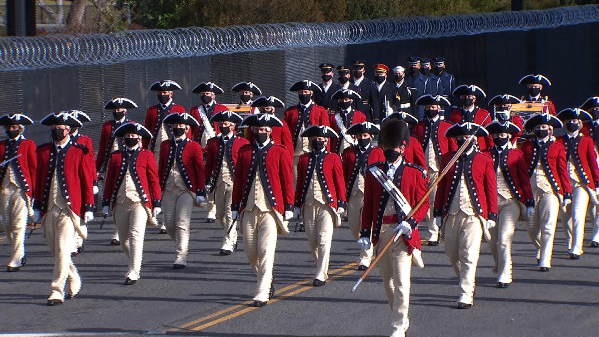 President Joe Biden and Vice President Kamala Harris participate in a pass in review on the East front of the Capitol with members of the military.