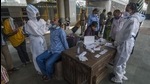 A healthcare worker collects the swab sample of a passenger at Dadar station on Thursday. (Pratik Chorge/HT Photo) A healthcare worker collects the swab sample of a passenger at Dadar station on Thursday. (Pratik Chorge/HT Photo)