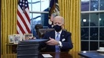 President Joe Biden signs his first executive orders in the Oval Office of the White House on January 20 in Washington, DC. (AP) President Joe Biden signs his first executive orders in the Oval Office of the White House on January 20 in Washington, DC. (AP)
