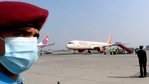 A policeman watches as an aircraft from India carrying Covishield, AstraZeneca-Oxford's Covid-19 coronavirus vaccine made by India's Serum Institute arrives at the Tribhuvan International Airport in Kathmandu on January 21, 2021.(AFP) A policeman watches as an aircraft from India carrying Covishield, AstraZeneca-Oxford's Covid-19 coronavirus vaccine made by India's Serum Institute arrives at the Tribhuvan International Airport in Kathmandu on January 21, 2021.(AFP)