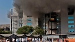 Workers wearing protective gear walk after a fire broke out at India's Serum Institute in Pune on January 21, 2021. (AFP) Workers wearing protective gear walk after a fire broke out at India's Serum Institute in Pune on January 21, 2021. (AFP)
