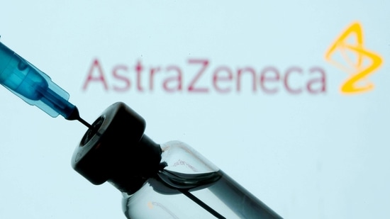 A vial and syringe are seen in front of a displayed AstraZeneca logo.(Reuters)