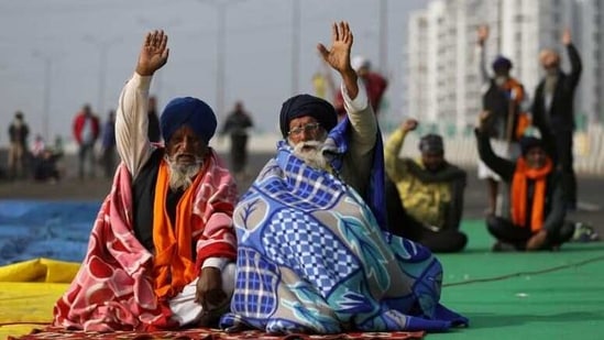 Farmers take part in a protest against the three farm laws on the outskirts of Delhi.(Reuters Photo)