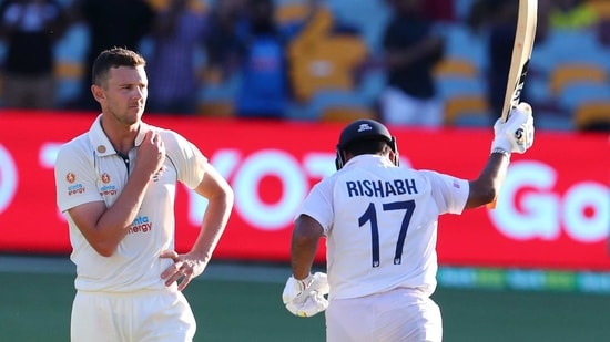 Australia's Josh Hazlewood reacts as India's Rishabh Pant, right, celebrates after hitting the winning runs to defeat Australia by three wickets on the final day of the fourth cricket test at the Gabba, Brisbane, Australia, Tuesday, Jan. 19, 2021.India won the four test series 2-1. (AP Photo/Tertius Pickard)(AP)