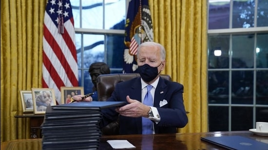President Joe Biden signs his first executive orders in the Oval Office of the White House on January 20 in Washington, DC. (AP) President Joe Biden signs his first executive orders in the Oval Office of the White House on January 20 in Washington, DC. (AP)