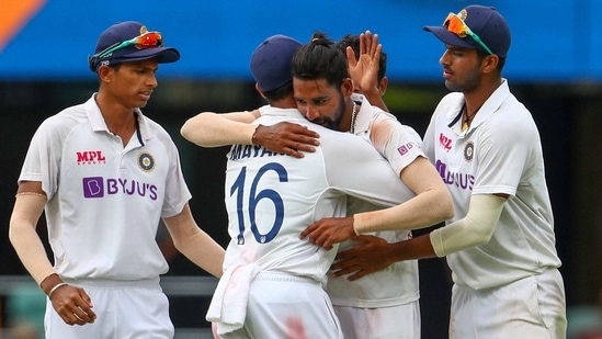 India's Mohammed Siraj, centre, celebrates with teammate Mayank Agarwal, second left, after taking his fifth wicket during play on day four of the fourth cricket test between India and Australia at the Gabba, Brisbane, Australia.(AP)