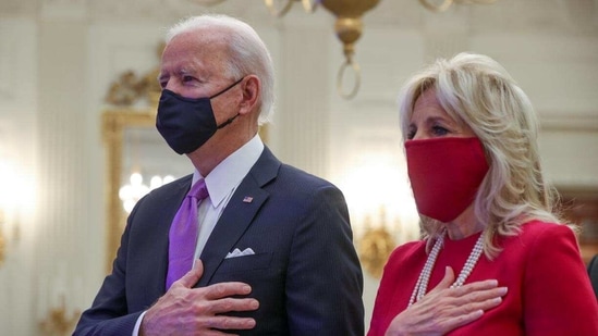 U.S. President Joe Biden and first lady Jill Biden stand for the national anthem sung by Patti LaBelle as they participate remotely in a virtual Presidential Inaugural Prayer Service from the State Dining Room at the White House in Washington, U.S., January 21, 2021.(Reuters) U.S. President Joe Biden and first lady Jill Biden stand for the national anthem sung by Patti LaBelle as they participate remotely in a virtual Presidential Inaugural Prayer Service from the State Dining Room at the White House in Washington, U.S., January 21, 2021.(Reuters)