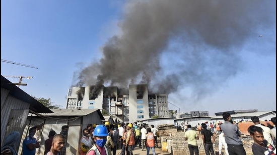 Workers rush out of the building after fire breaks out at Serum Institute of India, Pune, on Thursday. (PTI) Workers rush out of the building after fire breaks out at Serum Institute of India, Pune, on Thursday. (PTI)