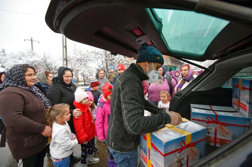 Valeriu Nicolae distributes boxes containing basic food, hygiene and medicinal products.(AP) Valeriu Nicolae distributes boxes containing basic food, hygiene and medicinal products.(AP)